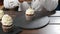 Baker decorating tasty cupcake with cream at table. Food and confectionery concept