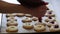 Baker filling pastry with jam in bakery