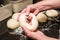 Baker forming bagels from dough