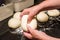 Baker forming bagels from dough