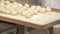 baker forming dough in bakery