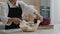 Baker girl takes out ready baked bread.