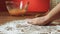 Baker hand preparing flour on the table to make dough slow motion