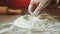 Baker hand preparing flour on the table to make dough, slow motion, 240 fps. Cooking and backing preparation. Food