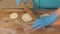 Baker hand rolling dough before baking pastries on table in bakehouse close up