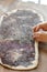 Baker hands at bakery house rolled buns with poppy seeds baking sheet pan wooden table with flour bread white