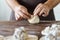 Baker hands at bakery house rolled buns with poppy seeds baking sheet pan wooden table with flour bread white