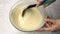 Baker hands knead the dough in a glass bowl. Cooking dough, baking ingredients