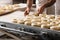 Baker hands making bread donuts