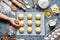 Baker hands preparing dough for buns recipe ingridients food flat lay