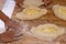 Baker hands preparing khachapuri on kitchen table. A child prepares a traditional Georgian dish - khachapuri with cheese from