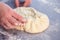 Baker hands preparing khachapuri on kitchen table. View on cook