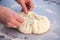 Baker hands preparing khachapuri on kitchen table. View on cook