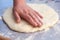 Baker hands preparing khachapuri on kitchen table. View on cook