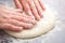 Baker hands preparing khachapuri on kitchen table. View on cook