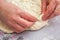 Baker hands preparing khachapuri on kitchen table. View on cook