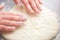 Baker hands preparing khachapuri on kitchen table. View on cook