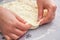 Baker hands preparing khachapuri on kitchen table. View on cook