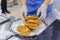 Baker hands puts fresh heart shaped buns on plate - professional cooking concept