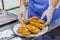 Baker hands puts fresh heart shaped buns on plate - professional cooking concept