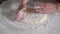 Baker hands rolling fresh dough. Woman preparation traditional Ossetian pie