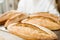 baker holding tray with fresh loaves