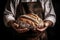 baker holds fresh, fragrant, delicious bread in his hand