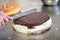 Baker icing a chocolate cake