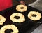 Baker in a industrial bakery with baking tray