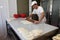 A baker knead dough for cheese pie with roller and flour in bakery in the city of Sofia, Bulgaria â€“ sep 4 , 2015. Chef prepares