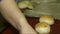 A baker lubricates the buns and sprinkle them dusting