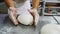 Baker makes bread loaf of dough on metal table slow motion