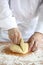 Baker making bread,cutting a dough