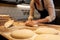 Baker making bread dough at bakery kitchen