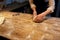 Baker making bread dough at bakery kitchen