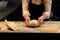 Baker making bread dough at bakery kitchen