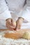 Baker making bread, kneading a dough