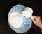 Baker measuring flour into bowl