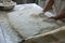 Baker Placing Raw Ciabatta Bread on Tray