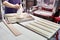 Baker pours flour on bread loaves before baking