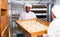 Baker preparing formed bread dough for proofing in bakery