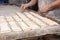 Baker preparing uncooked bread dough loaves ready to bake