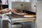 Baker puts raw pizza in an industrial oven