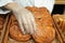 Baker putting fresh bun onto tray