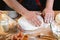 Baker rolling dough with flour bread, pizza or pie recipe ingredients with hands, food on kitchen table background, working with m