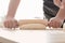 Baker rolling dough on kitchen table