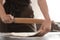 Baker rolling dough on kitchen table