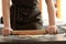 Baker rolling dough on kitchen table