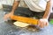 Baker Rolling Dough with Rolling Pin in Bakery