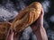 Baker`s hands hold fresh bread